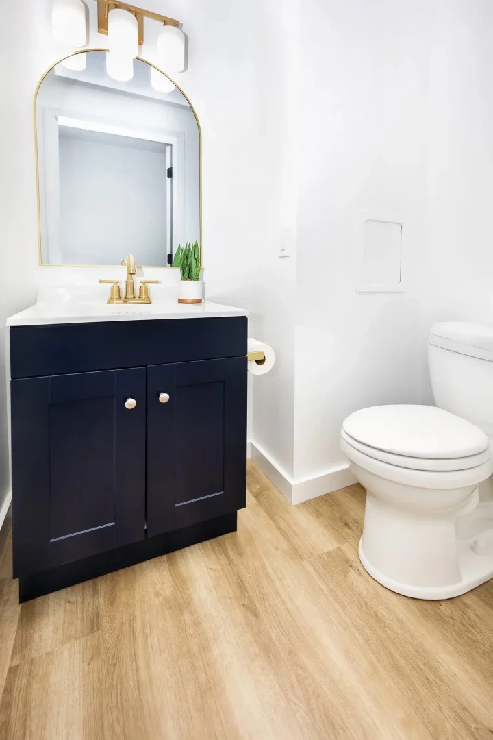 Bathroom renovation in Rochester NY with walk-in shower, gold fixtures, and custom vanity.
