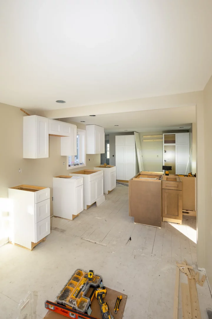 Installation of custom white cabinets during kitchen renovation in Fairport NY.