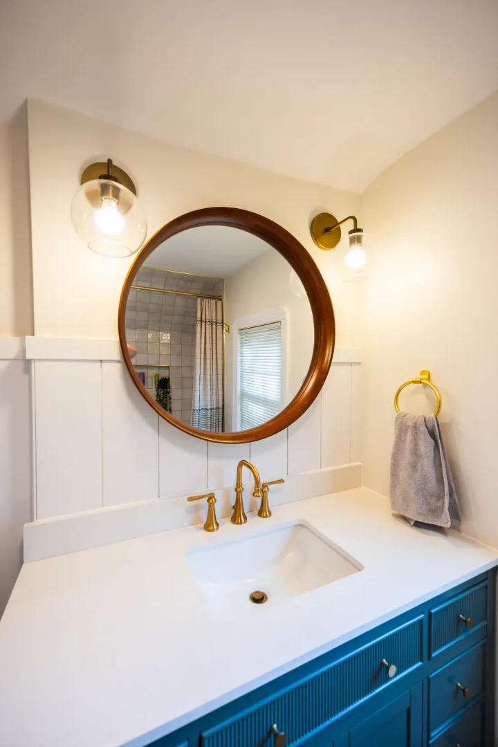 Rochester bathroom renovation – new teal vanity with gold faucet.